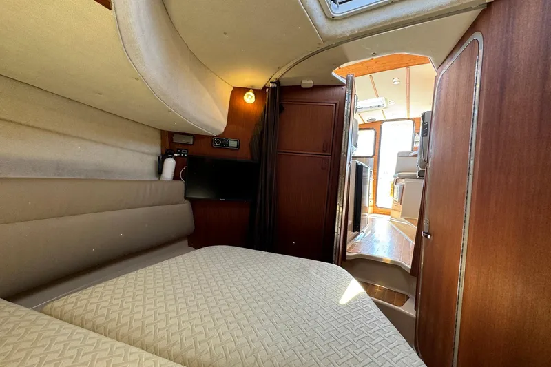 Point Aft'r Yacht Photos Pics 2012 Ranger Tugs R-29 interior cabin with cozy bed and wooden finishes.