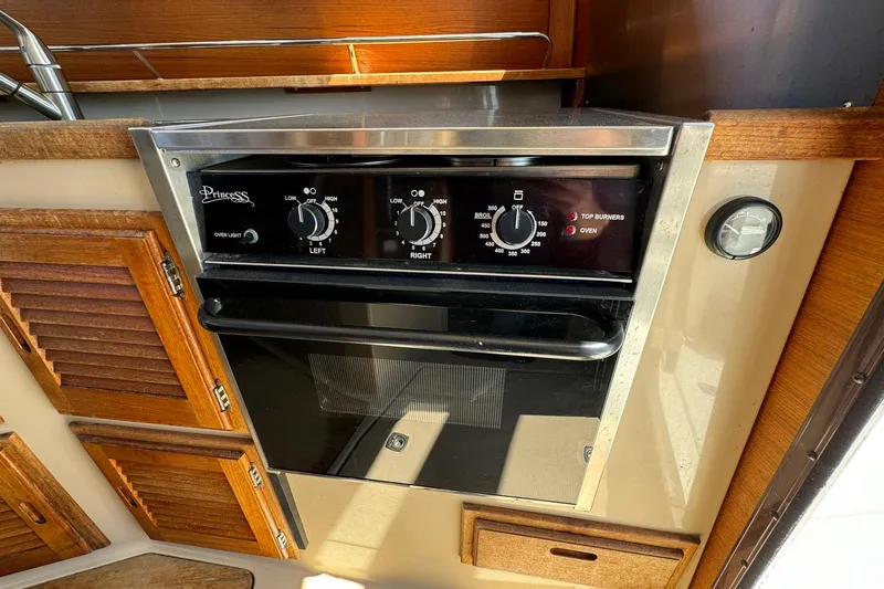 Point Aft'r Yacht Photos Pics Princess oven in 2012 Ranger Tugs R-29 boat kitchen, featuring wooden cabinetry.