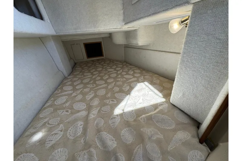 Point Aft'r Yacht Photos Pics Cozy cabin interior of 2012 Ranger Tugs R-29 with patterned bedding and soft lighting.