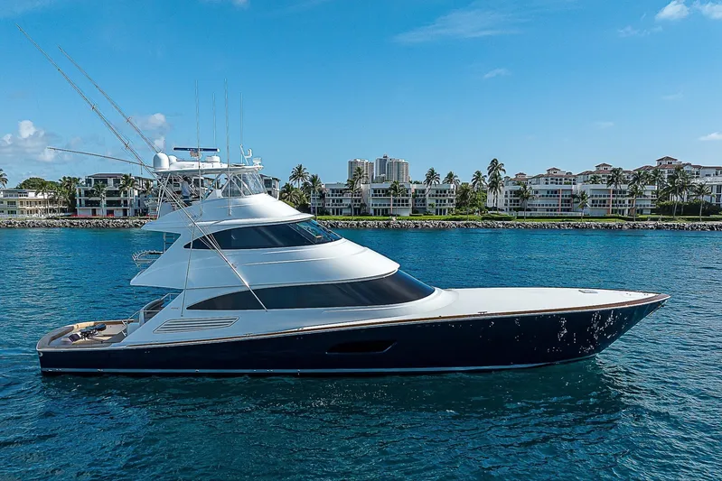 Bella Yacht Photos Pics 2018 Viking 92 Sky Bridge yacht cruising near luxury waterfront properties.