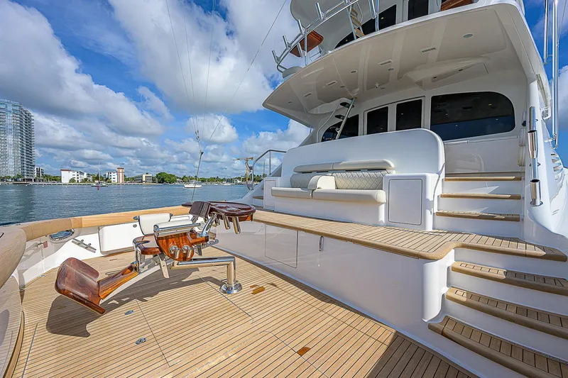 Bella Yacht Photos Pics 2018 Viking 92 Sky Bridge yacht deck with fishing chairs and scenic water view.