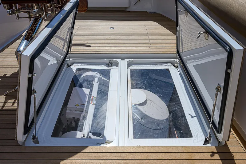 Bella Yacht Photos Pics 2018 Viking 92 Sky Bridge yacht with open engine compartment on teak deck.