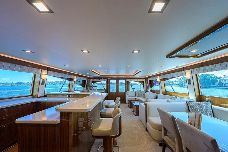 Bella Yacht Photos Pics Luxurious interior of 2018 Viking 92 Sky Bridge yacht with modern seating and panoramic windows.