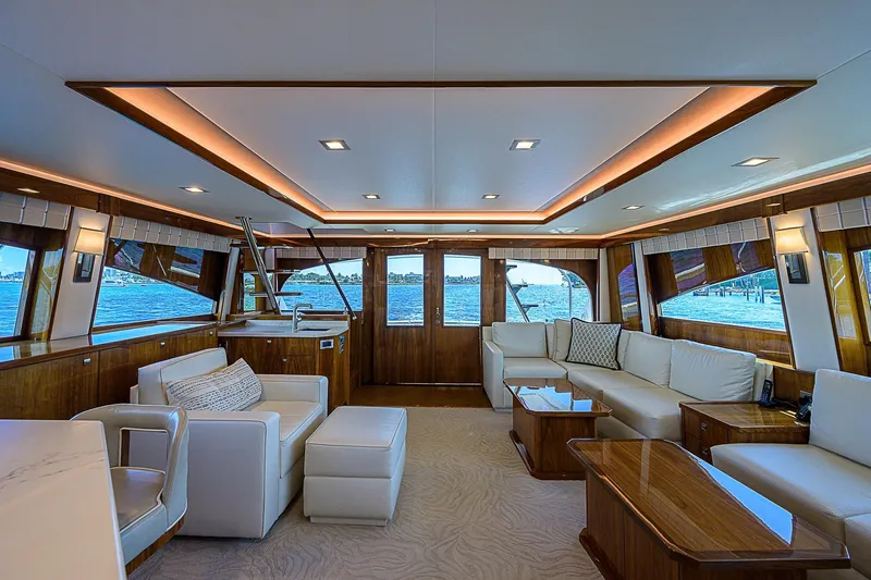 Bella Yacht Photos Pics Luxurious interior of 2018 Viking 92 Sky Bridge yacht with elegant seating and panoramic windows.