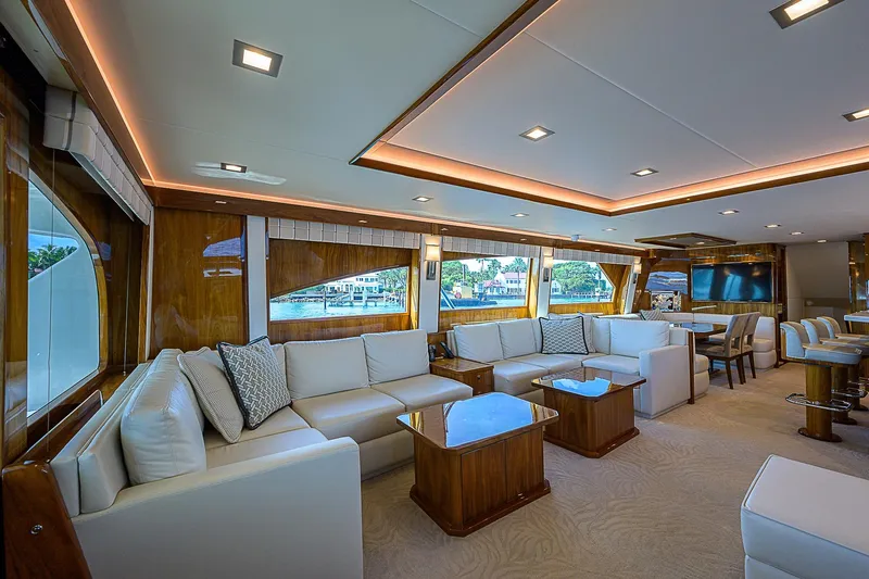 Bella Yacht Photos Pics Luxurious interior of 2018 Viking 92 Sky Bridge yacht with elegant seating and large windows.