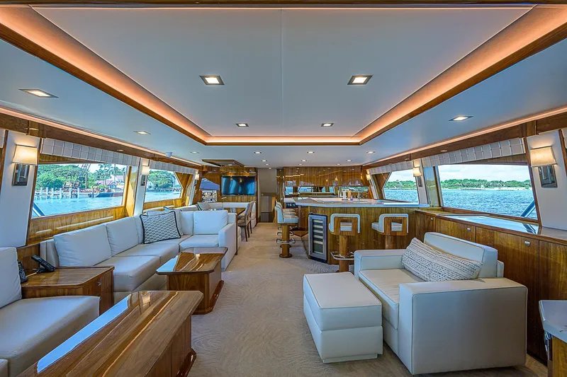 Bella Yacht Photos Pics Luxurious interior of 2018 Viking 92 Sky Bridge yacht with modern furnishings and panoramic windows.