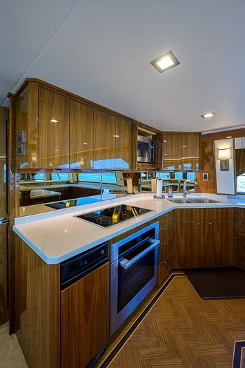 Bella Yacht Photos Pics Modern kitchen in 2018 Viking 92 Sky Bridge yacht with sleek wood cabinetry and built-in appliances.