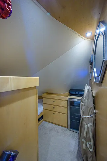 Bella Yacht Photos Pics 2018 Viking 92 Sky Bridge interior cabin with storage drawers and mirror.