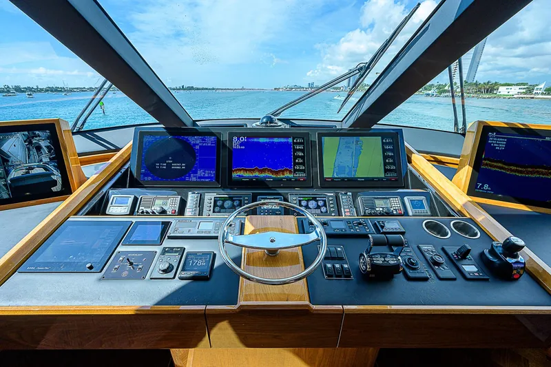 Bella Yacht Photos Pics Cockpit view of 2018 Viking 92 Sky Bridge yacht with advanced navigation systems.