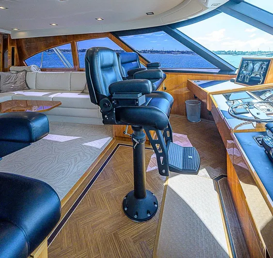 Bella Yacht Photos Pics Luxurious interior of 2018 Viking 92 Sky Bridge yacht with captain's chairs and panoramic windows.