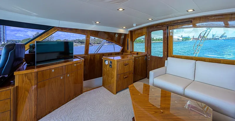 Bella Yacht Photos Pics Luxurious interior of 2018 Viking 92 Sky Bridge yacht with wood finishes and waterfront view.