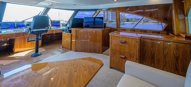 Bella Yacht Photos Pics Luxurious interior of a 2018 Viking 92 Sky Bridge yacht with polished wood finishes.