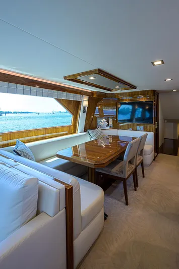 Bella Yacht Photos Pics Luxurious interior of 2018 Viking 92 Sky Bridge yacht with elegant dining area.