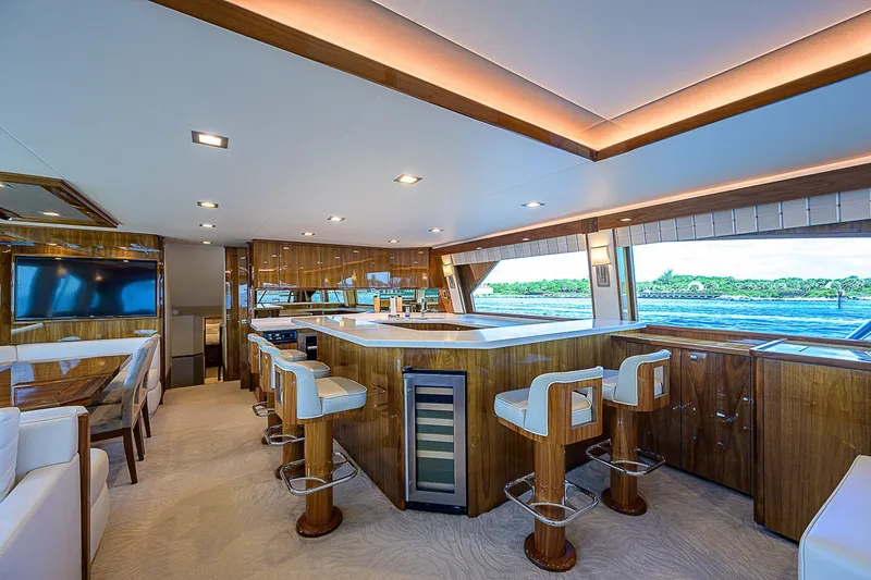 Bella Yacht Photos Pics Luxurious interior of 2018 Viking 92 Sky Bridge yacht with modern kitchen and seating area.