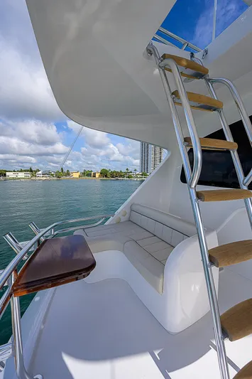 Bella Yacht Photos Pics 2018 Viking 92 Sky Bridge yacht with seating area and ladder.