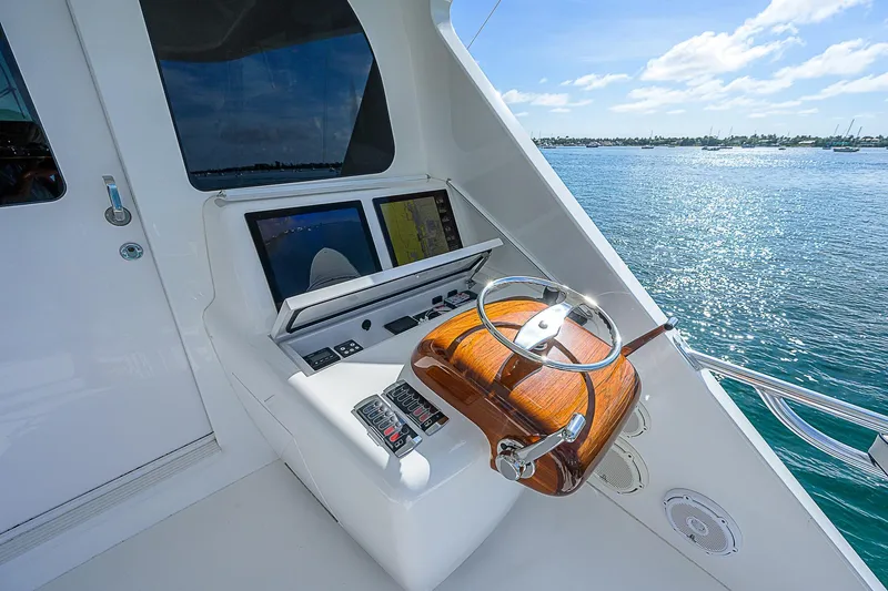 Bella Yacht Photos Pics 2018 Viking 92 Sky Bridge helm station with dual screens and wooden steering wheel.