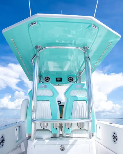  Yacht Photos Pics 2024 Dynamic D-305V boat with teal and white seating, ocean backdrop.