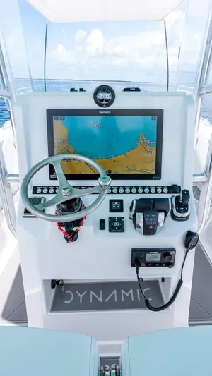  Yacht Photos Pics 2024 Dynamic D-305V boat dashboard with navigation screen and steering wheel.