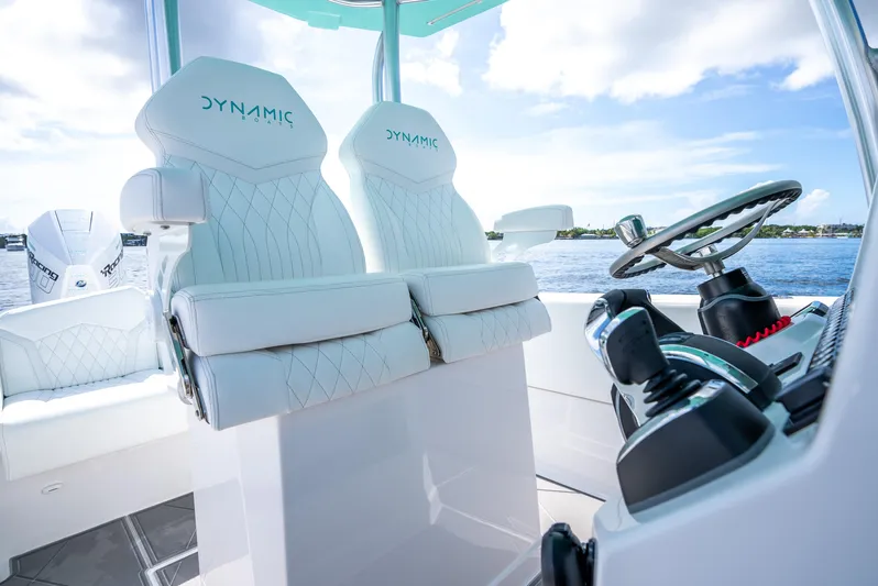  Yacht Photos Pics 2024 Dynamic D-305V boat interior with luxurious white seating and modern controls.