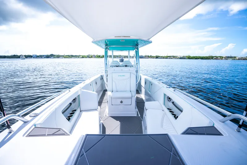  Yacht Photos Pics 2024 Dynamic D-305V boat interior with seating, helm station, and open water view.