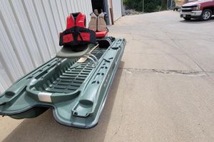 2007 Pelican Bass Raider 10 boat with life jackets on concrete surface.