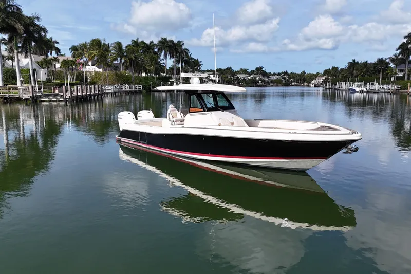  Yacht Photos Pics 2020 Chris-Craft Catalina 34 boat on a serene waterway with palm trees.