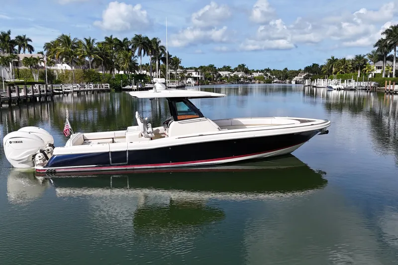  Yacht Photos Pics 2020 Chris-Craft Catalina 34 boat on a calm, scenic waterway with palm trees.