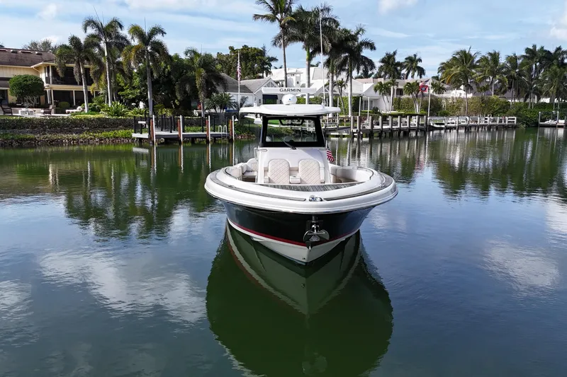  Yacht Photos Pics 2020 Chris-Craft Catalina 34 boat docked in a scenic, palm-lined marina.