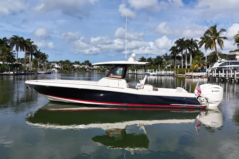  Yacht Photos Pics 2020 Chris-Craft Catalina 34 boat on calm water with palm trees in the background.