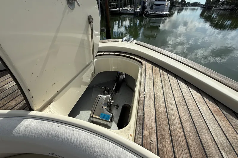  Yacht Photos Pics 2020 Chris-Craft Catalina 34 anchor compartment with open hatch, docked by calm waters.