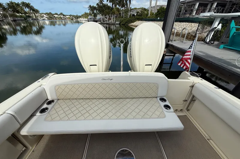  Yacht Photos Pics 2020 Chris-Craft Catalina 34 boat with cushioned seating and dual engines, docked by a serene waterway.