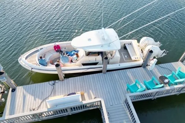  Yacht Photos Pics 2020 Chris-Craft Catalina 34 docked, aerial view, with people relaxing onboard.