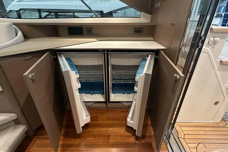 F45079 Yacht Photos Pics Modern kitchen area on 2022 Princess F45 yacht with open double-door refrigerator.