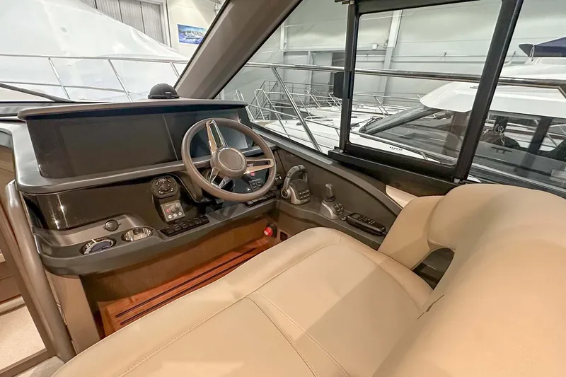 F45079 Yacht Photos Pics Interior helm of 2022 Princess F45 yacht with modern steering and controls.