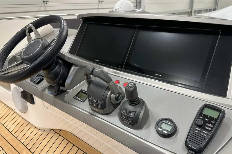 F45079 Yacht Photos Pics Control panel of 2022 Princess F45 yacht with steering wheel and navigation screens.