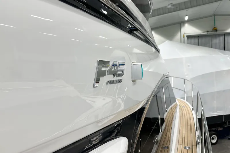 F45079 Yacht Photos Pics 2022 Princess F45 yacht in a showroom, showcasing sleek design and branding.