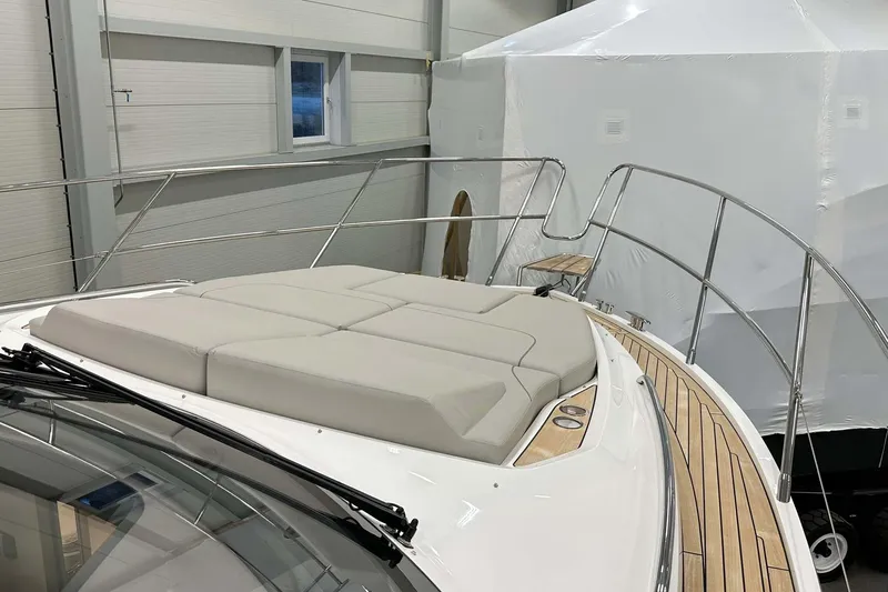 F45079 Yacht Photos Pics 2022 Princess F45 yacht with cushioned deck, sleek design, and wooden accents in a showroom.
