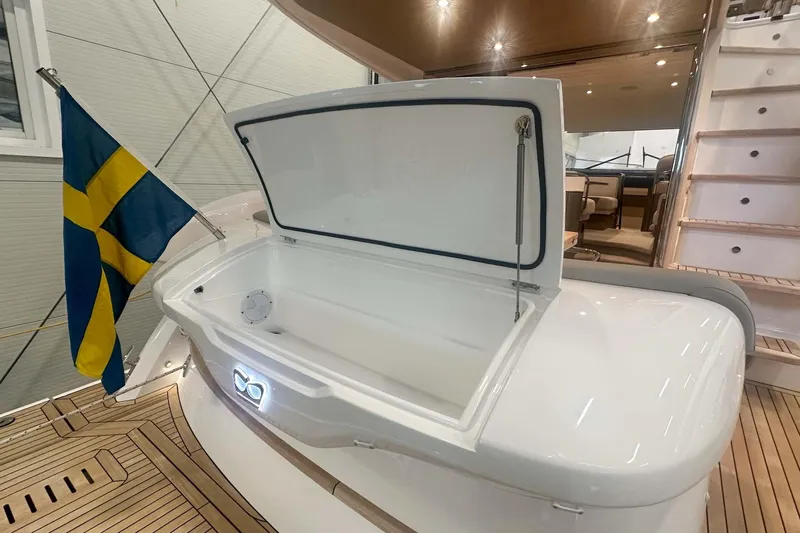 F45079 Yacht Photos Pics 2022 Princess F45 yacht deck with open storage, Swedish flag, and elegant interior.