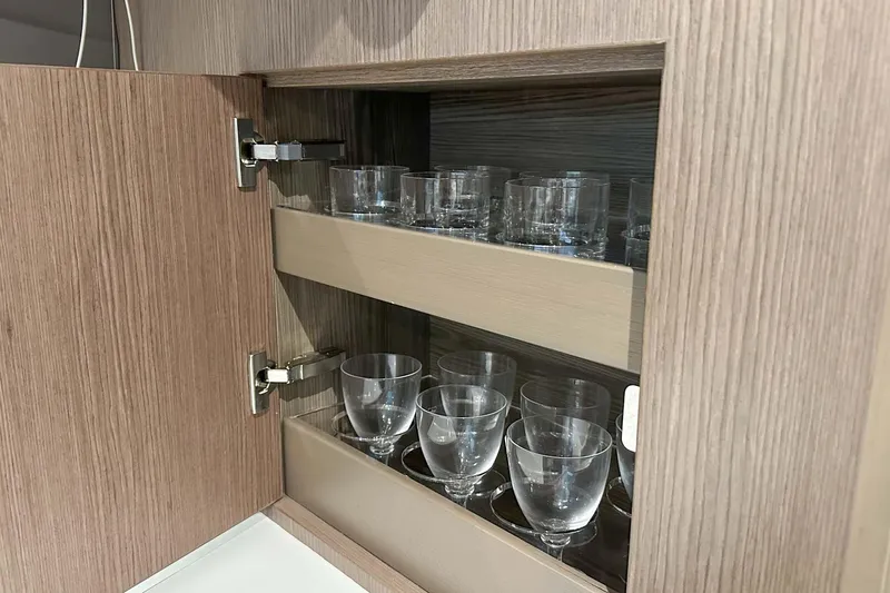 F45079 Yacht Photos Pics Wooden cabinet with glassware inside, part of a 2022 Princess F45 model.