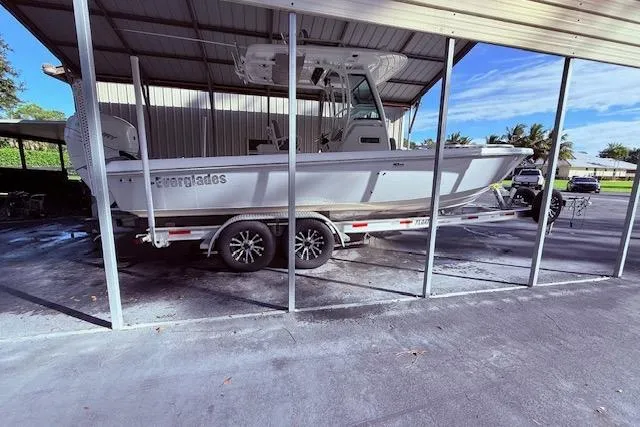  Yacht Photos Pics 2023 Everglades 253 Center Console boat on trailer in covered storage area.