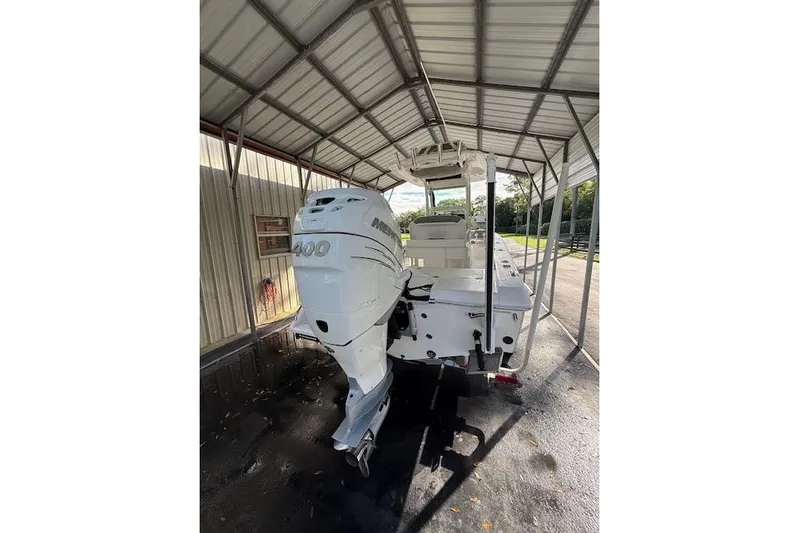  Yacht Photos Pics 2023 Everglades 253 Center Console boat with Mercury 400 engine under a metal canopy.