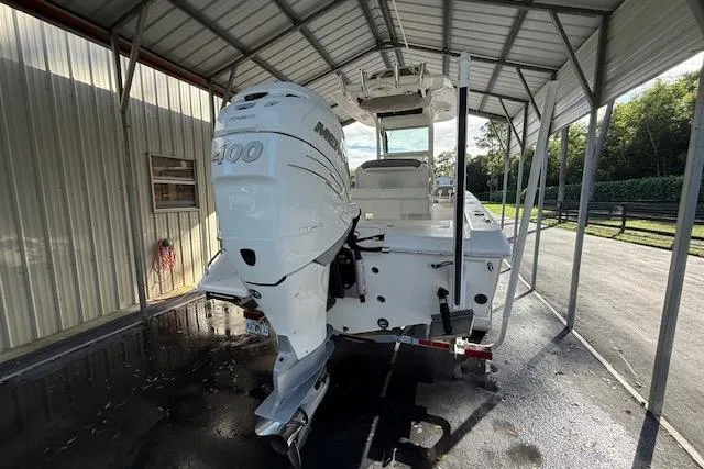  Yacht Photos Pics 2023 Everglades 253 Center Console boat with powerful outboard motor under a metal canopy.