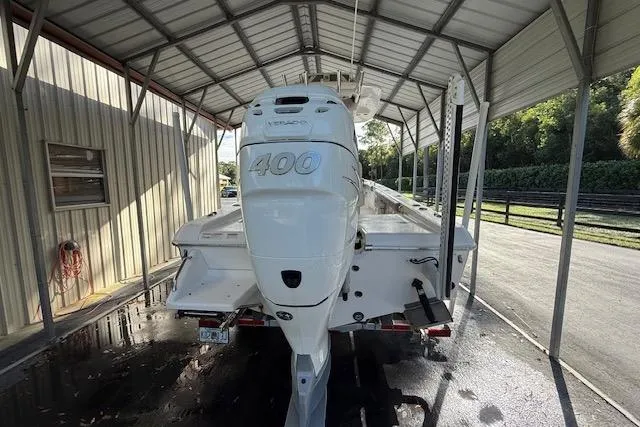  Yacht Photos Pics 2023 Everglades 253 Center Console boat with powerful 400 engine under a metal canopy.