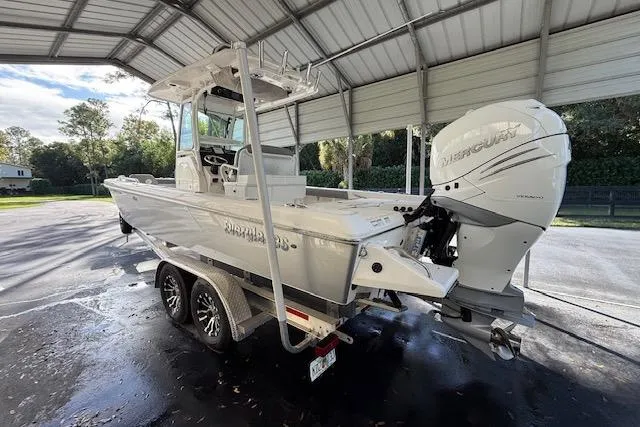  Yacht Photos Pics 2023 Everglades 253 Center Console boat under a metal canopy, featuring a powerful outboard engine.