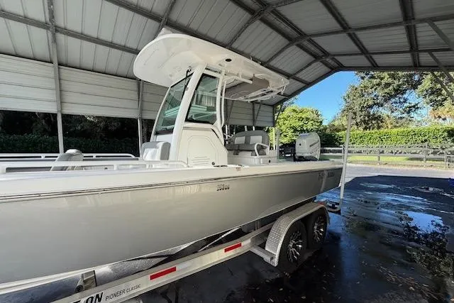 Yacht Photos Pics 2023 Everglades 253 Center Console boat on trailer under shelter.