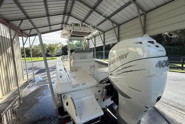  Yacht Photos Pics 2023 Everglades 253 Center Console boat with Mercury 400 engine under a metal canopy.