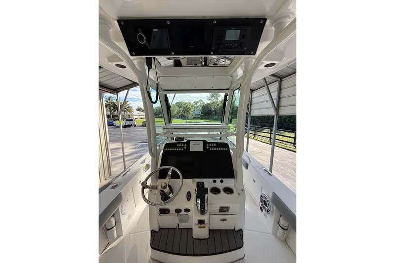  Yacht Photos Pics 2023 Everglades 253 Center Console boat interior with steering wheel and control panel.