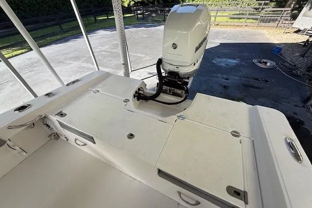  Yacht Photos Pics 2023 Everglades 253 Center Console boat with outboard motor in a covered area.