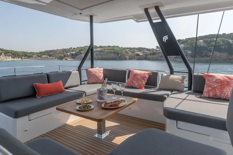  Yacht Photos Pics Luxurious 2026 Fountaine Pajot Samana 59 yacht with elegant outdoor seating and scenic ocean view.