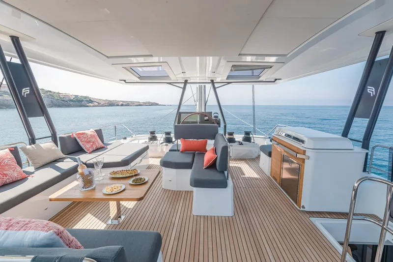  Yacht Photos Pics Luxurious 2026 Fountaine Pajot Samana 59 yacht deck with elegant seating and ocean view.
